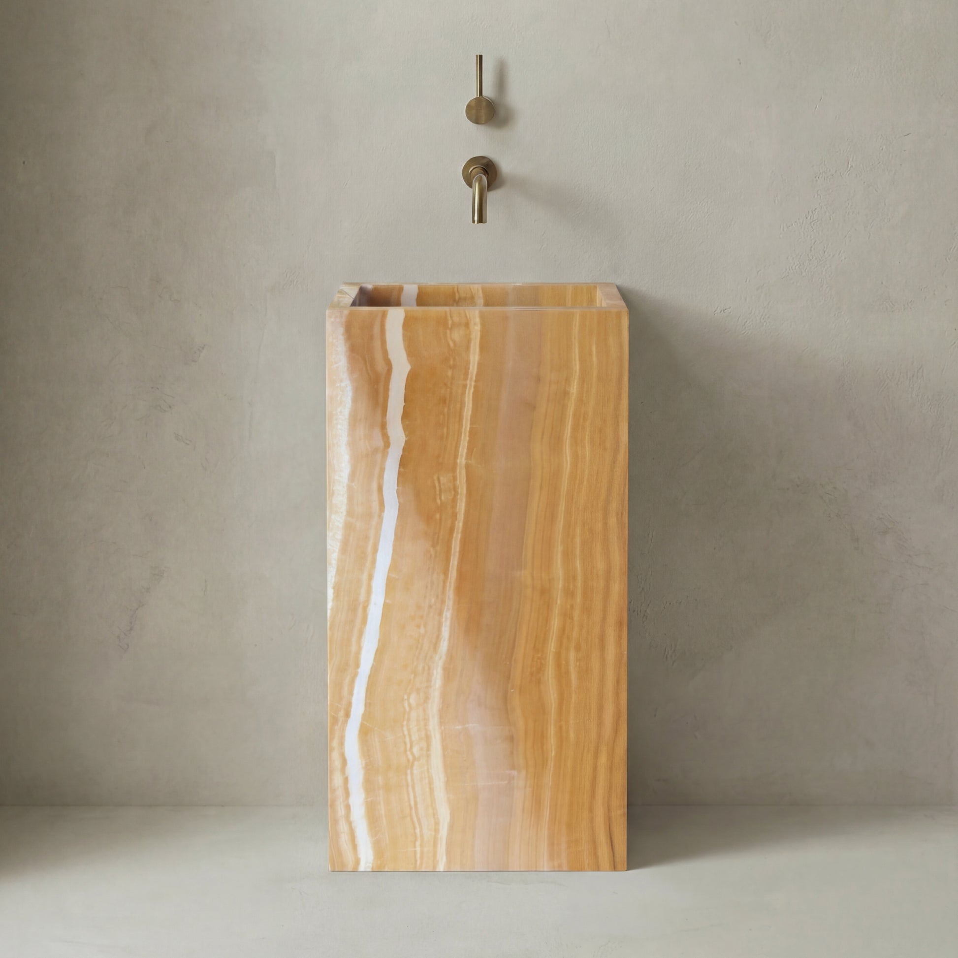 Lavabo Totem Seren en Ónix Dorado sin agujero, piedra semipreciosa pulida de tonos cálidos y dorados.