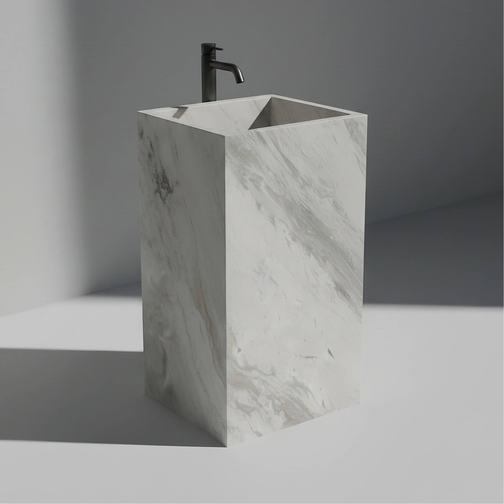 Lavabo Totem Seren en Mármol Volakas sin agujero, mármol blanco pulido con vetas grises diagonales.