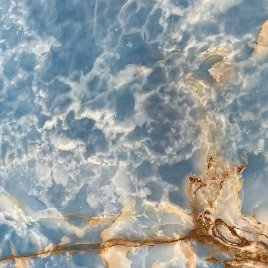 Ocean Blue onyx detail, blue and white veins, polished translucent texture.